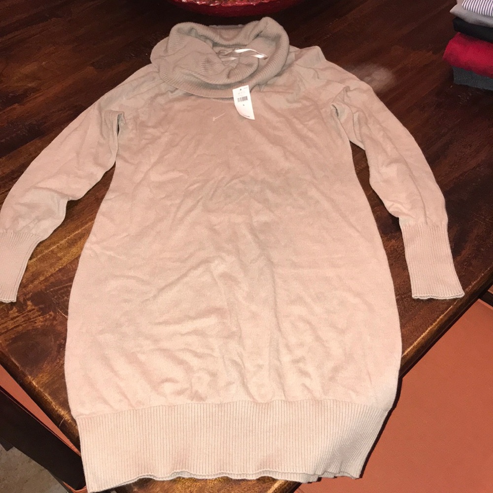 Beige tunic turtleneck type dress.